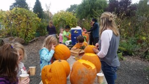 Kids carve pumpkins and enjoy homemade hot cocoa