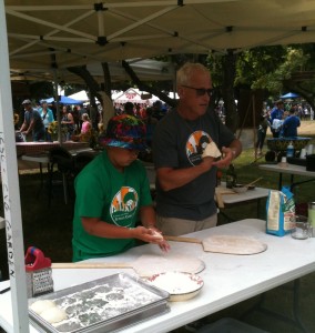 Students and school garden volunteers shape the dough for garden pizzas.
